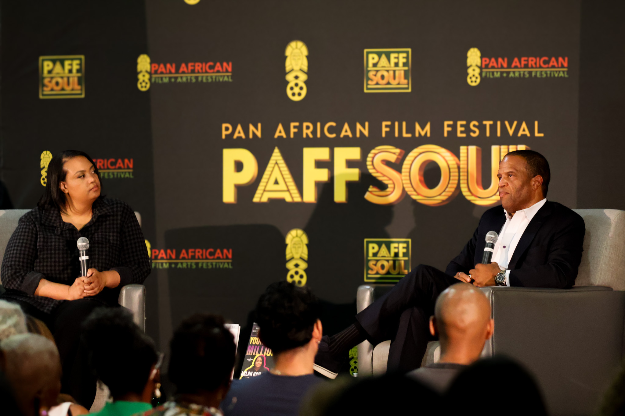 John Hope Bryant and Arlan Hamilton in conversation on stage at the Pan African Film Festival backdrop