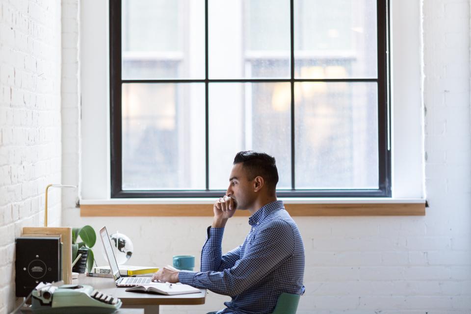 A young entrepreneur thinking at his desk