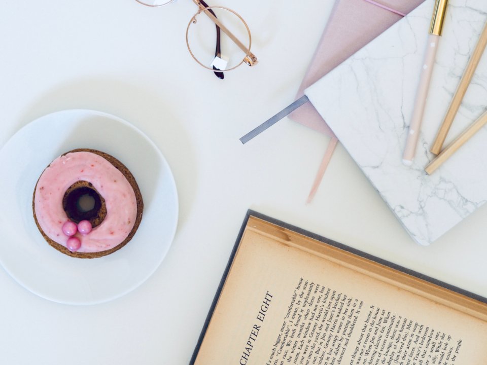 A notebook and coffee on a desk