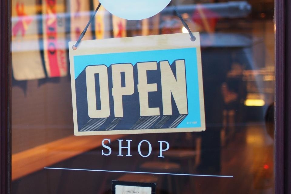 An "Open" sign on a shop door