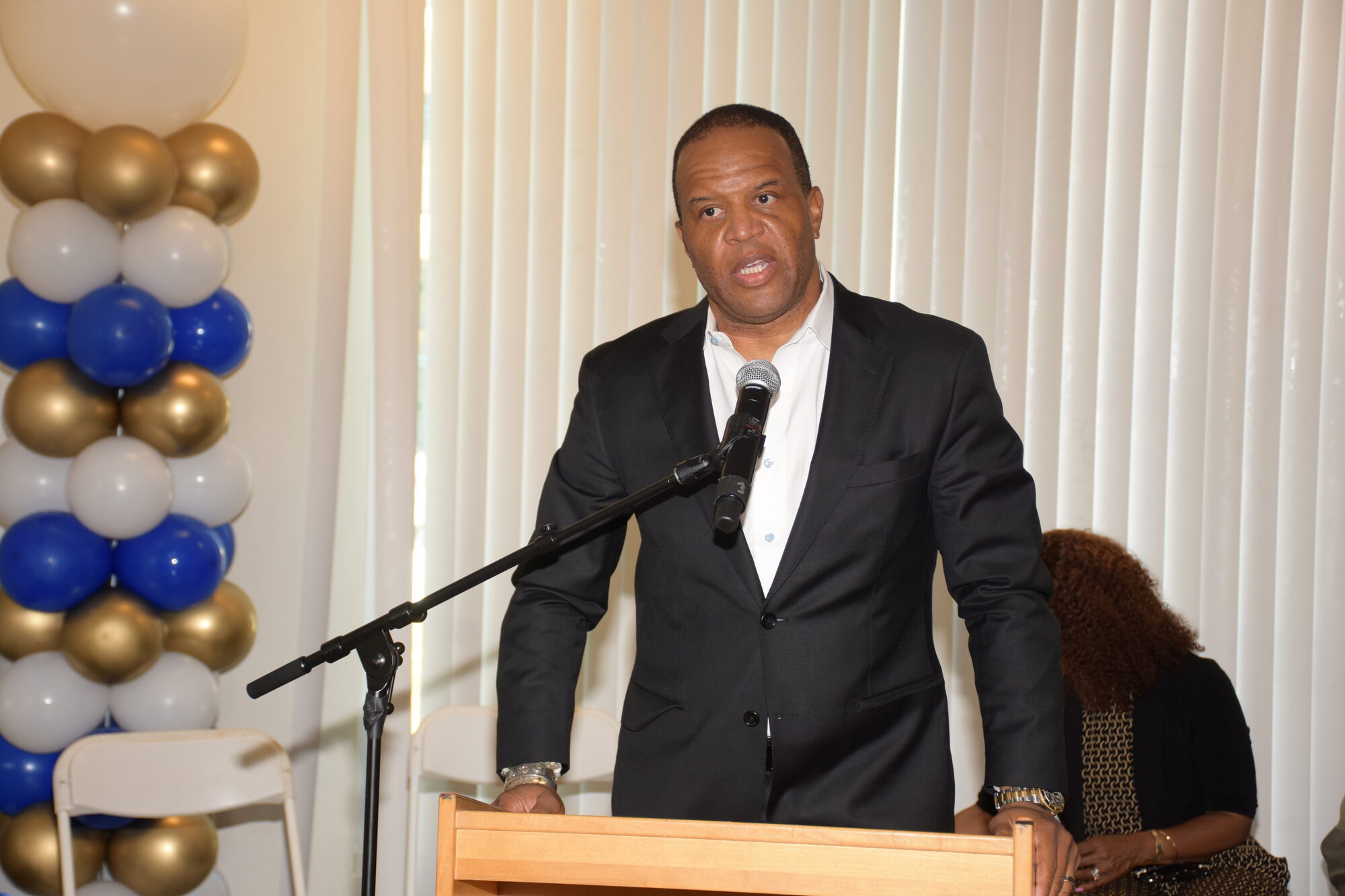 John Hope Bryant, Founder, Chairman, and CEO of Operation HOPE, speaks at a podium at the Wealth Building Meets AI forum in Los Angeles, Sept. 10, 2026.