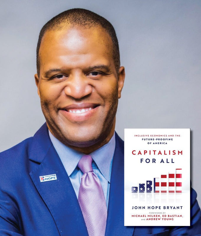 John Hope Bryant with his book Capitalism for All